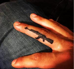 AK47 tattoo on finger