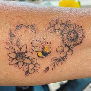 Bee  flowers tattoo on the inner arm