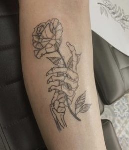 Skeleton Hand Holding Rose Tattoo