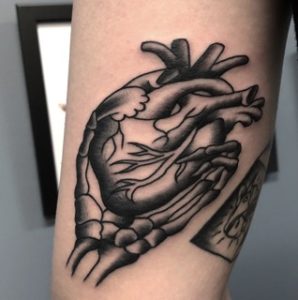 Skeleton Hand Holding Heart Tattoo