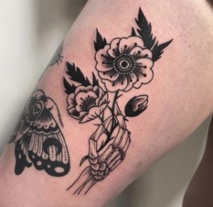 Skeleton Hand Holding Flowers Tattoo