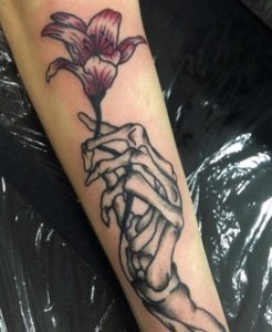 Skeleton Hand Holding Flowers Tattoo