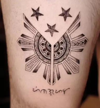 3 stars and a sun tattoo