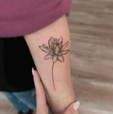 Minimalist water lily tattoo 