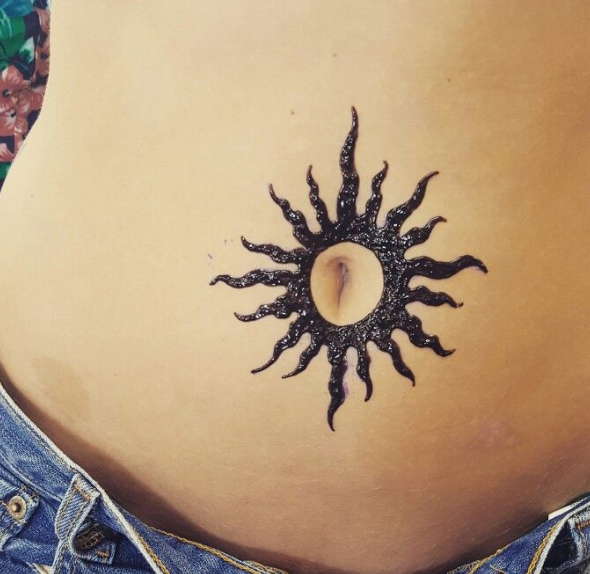 sun belly button tattoo