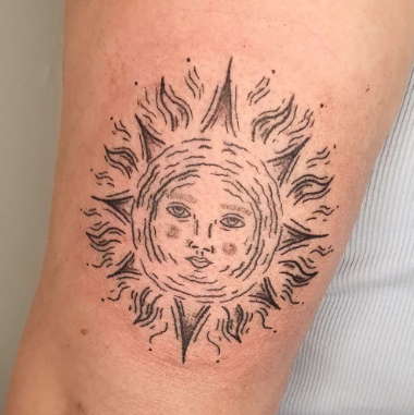 sun with a face tattoo