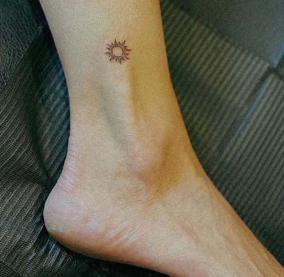 tiny sun tattoo
