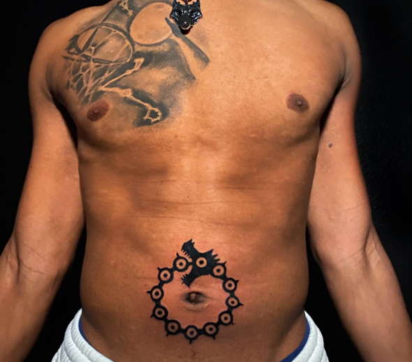 Men’s belly button tattoo