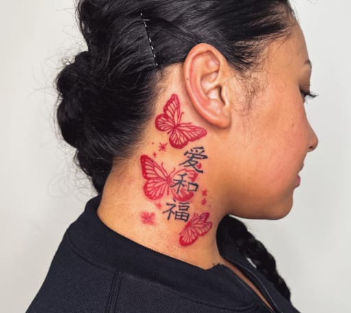 Red Butterfly Behind Ear Tattoo