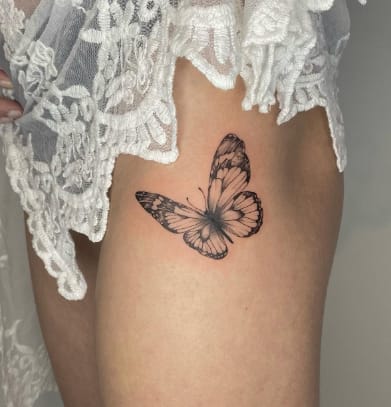 Small Butterfly Thigh Tattoo